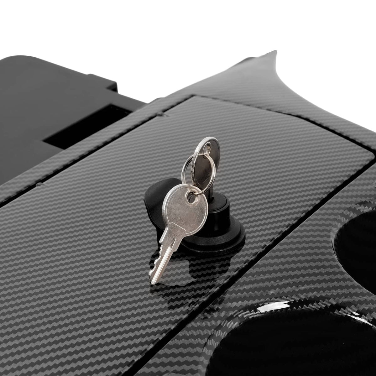 Carbon fiber-style dash insert close-up of key lock and two cup holder openings