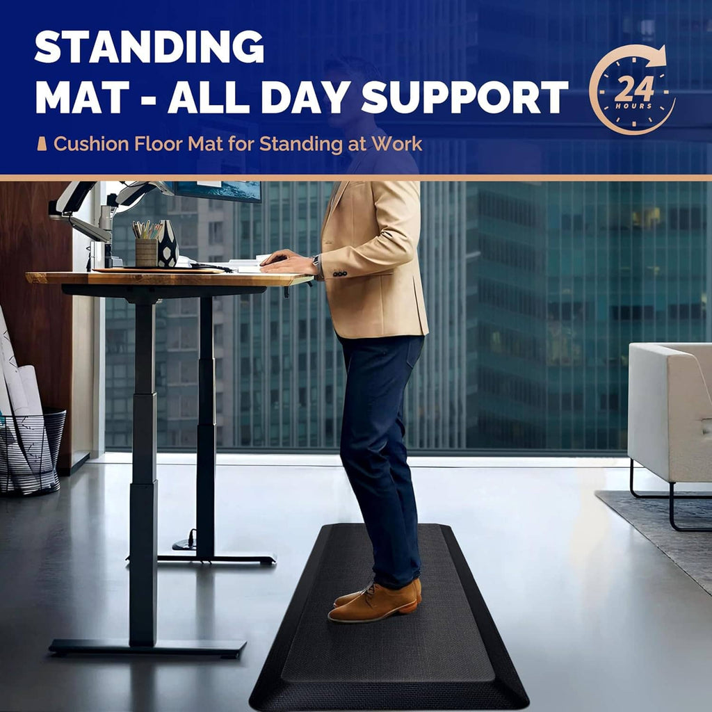 Dark textured anti-fatigue standing desk mat on floor under person’s shoes