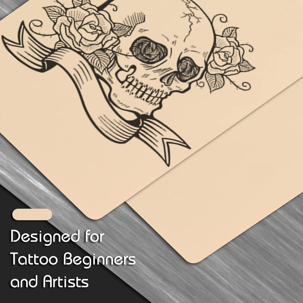 Beige tattoo practice skin sheets with black skull line-drawing stencil