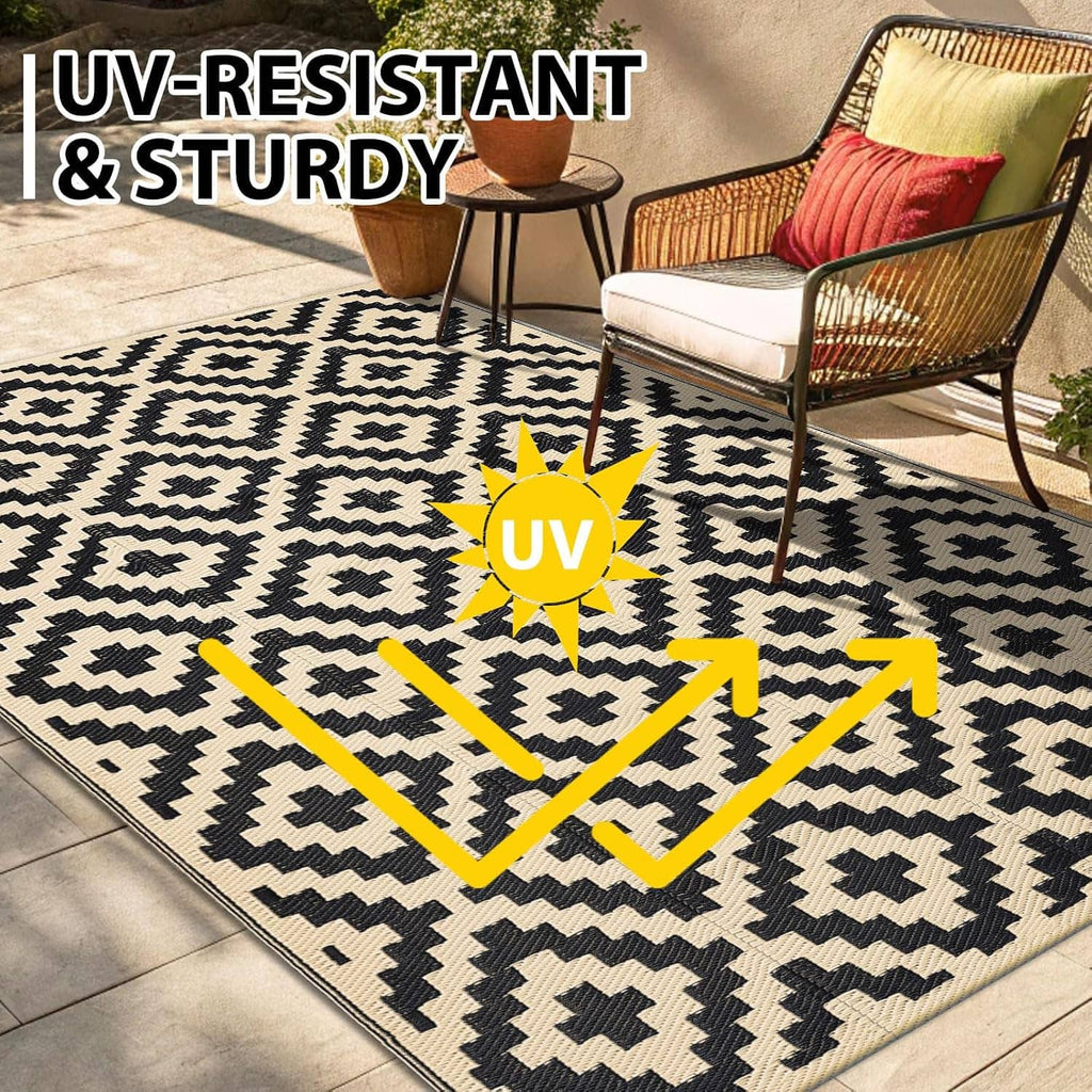 Black and beige geometric outdoor rug with diamond cross pattern and thick bordered edge.