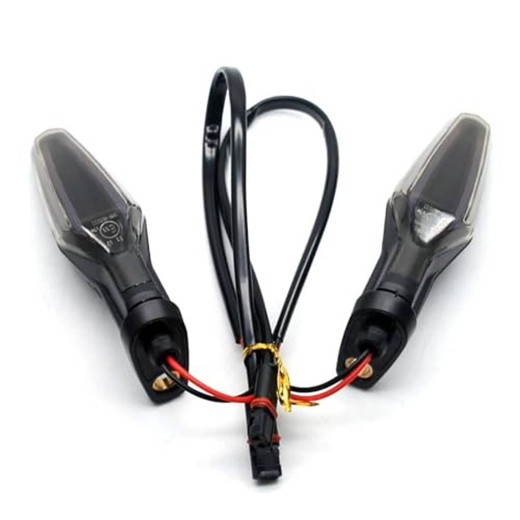Two motorcycle turn signal lights with smoked lenses, black housings, and red/black wires