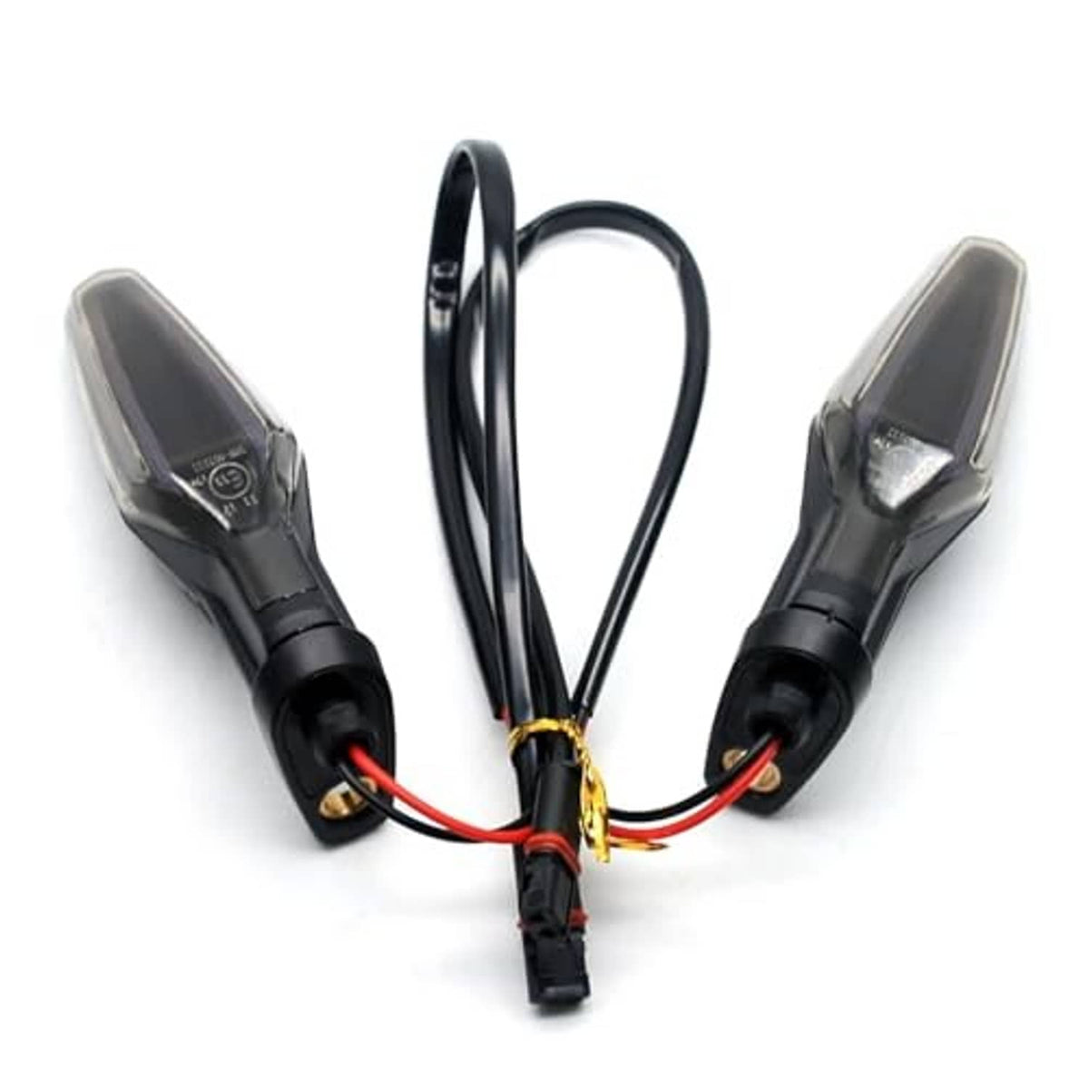 Two motorcycle turn signal lights with smoked lenses, black housings, and red/black wires