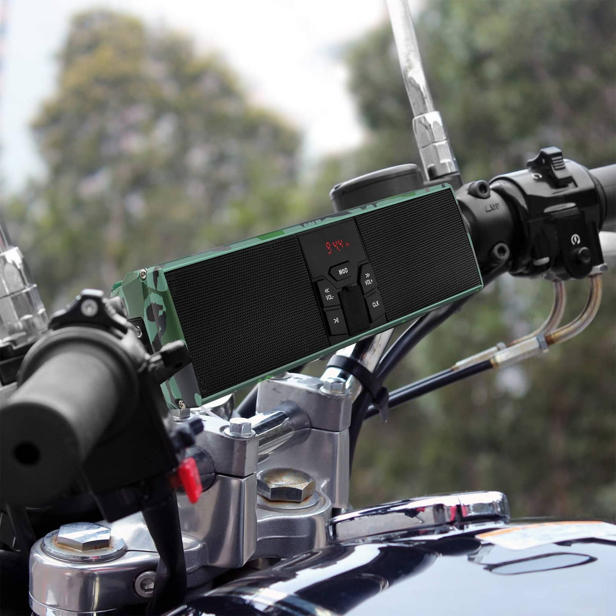 Camo green speaker bar mounted on handlebars with control panel and black speaker grille