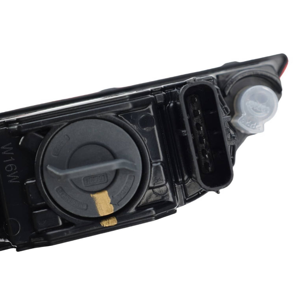 Close-up of black tail light housing with circular lamp and clear bulb cover