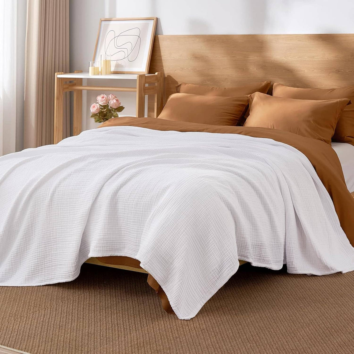 White muslin cotton king-size blanket over a bed with matching pillows