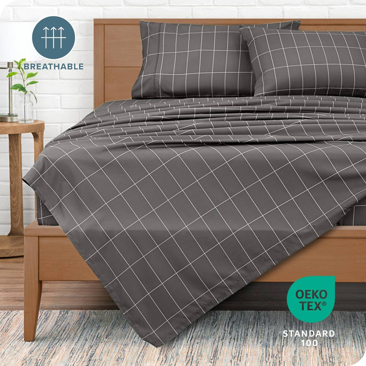 Grey bed sheet set with white grid pattern, shown on a deep mattress corner