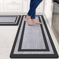 Kitchen mat runner with dark frame and light gray textured center, rectangular border