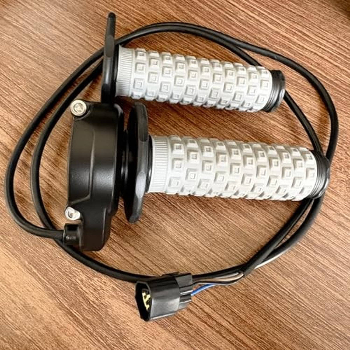Twist throttle assembly with gray knurled grips, black housing, and wiring harness