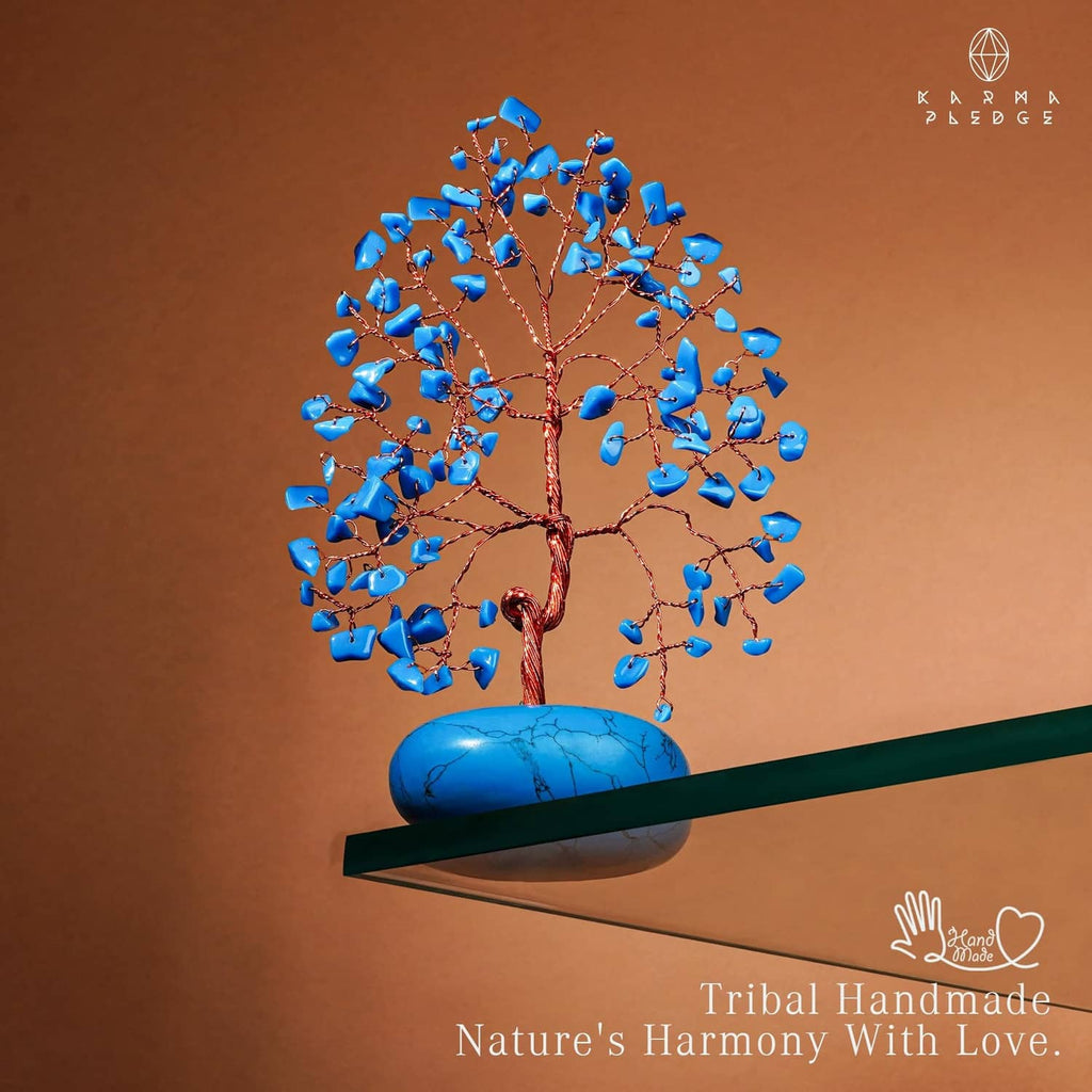 Turquoise crystal tree ornament with blue stone base and copper wire, placed beside rod