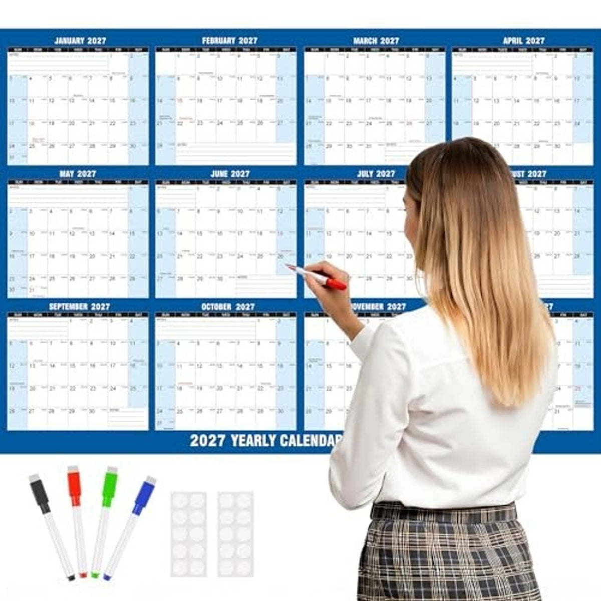 2027 wall calendar planner with blue frame, person writing with red marker