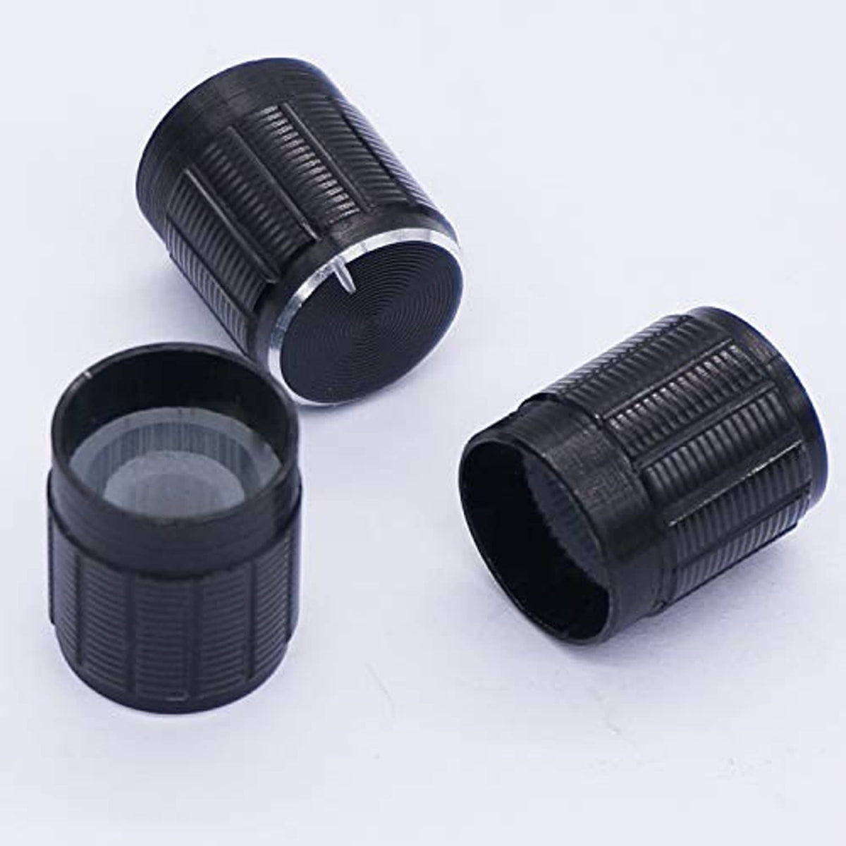 Black textured potentiometer knob housings with ridged grip surfaces