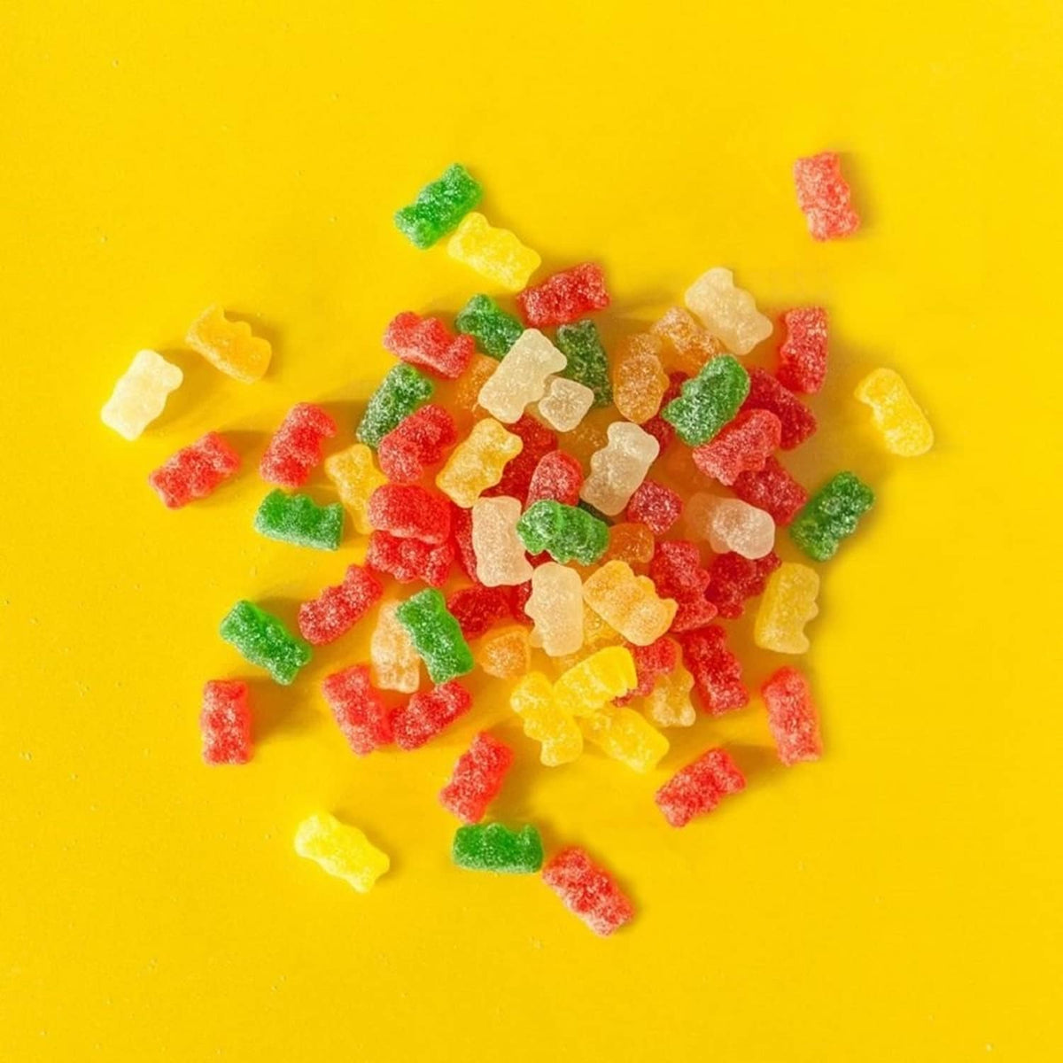 Assorted gummy bear pieces in red, yellow, green, and orange