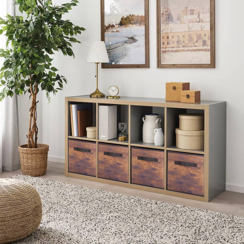 Fabric storage bins with wood-grain front panels and black pull handles in a console cabinet.