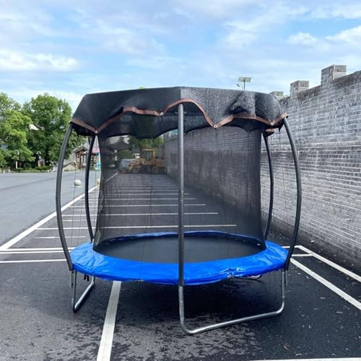 14ft round trampoline with dark mesh shade canopy and fitted edge ties