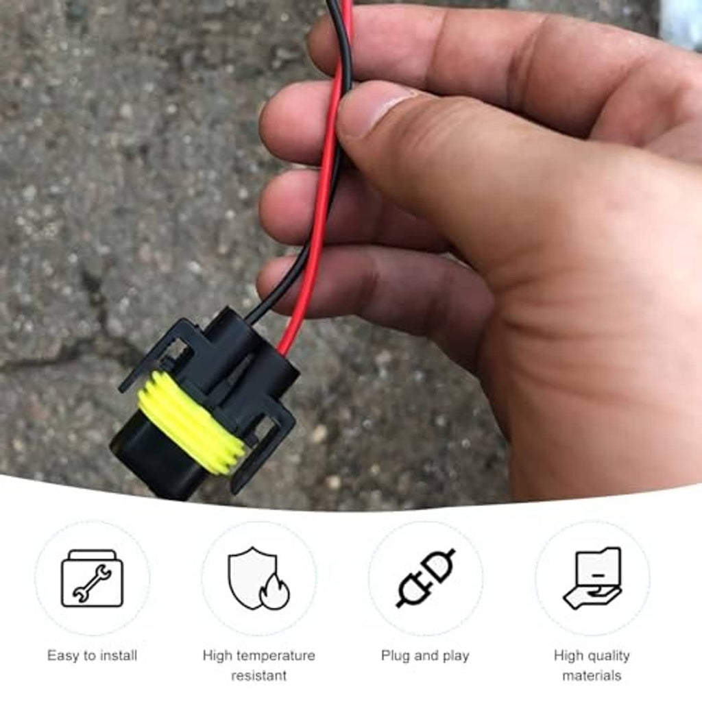 Hand holds headlight wiring harness connector with yellow-ring plug and red/black wires