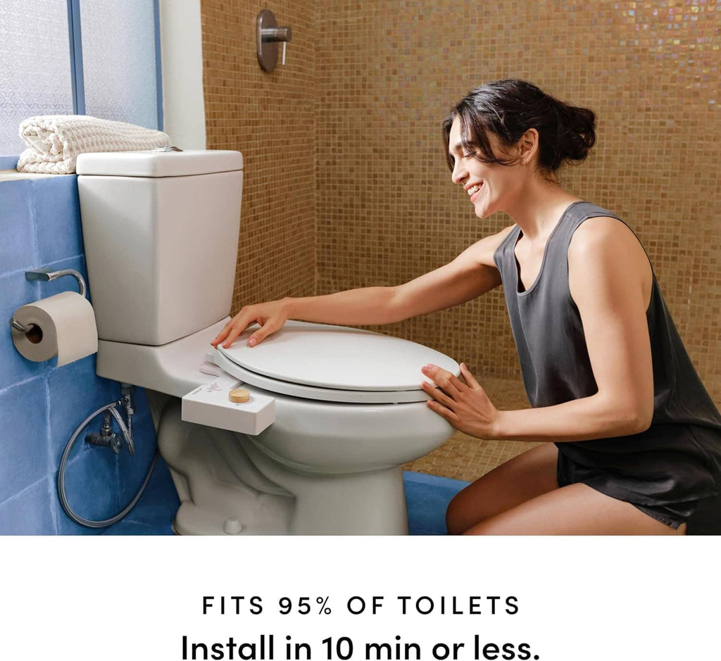 White non-electric bidet attachment on toilet with person adjusting the seat
