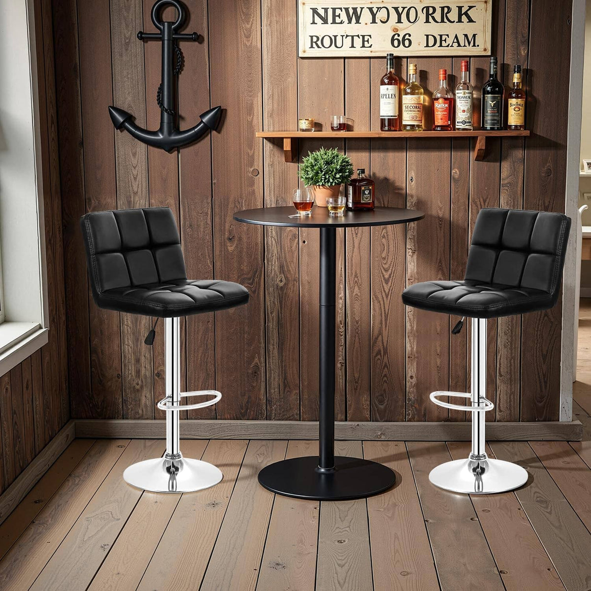 Set of 2 black PU leather swivel bar stools with padded seat and chrome footrest rings.