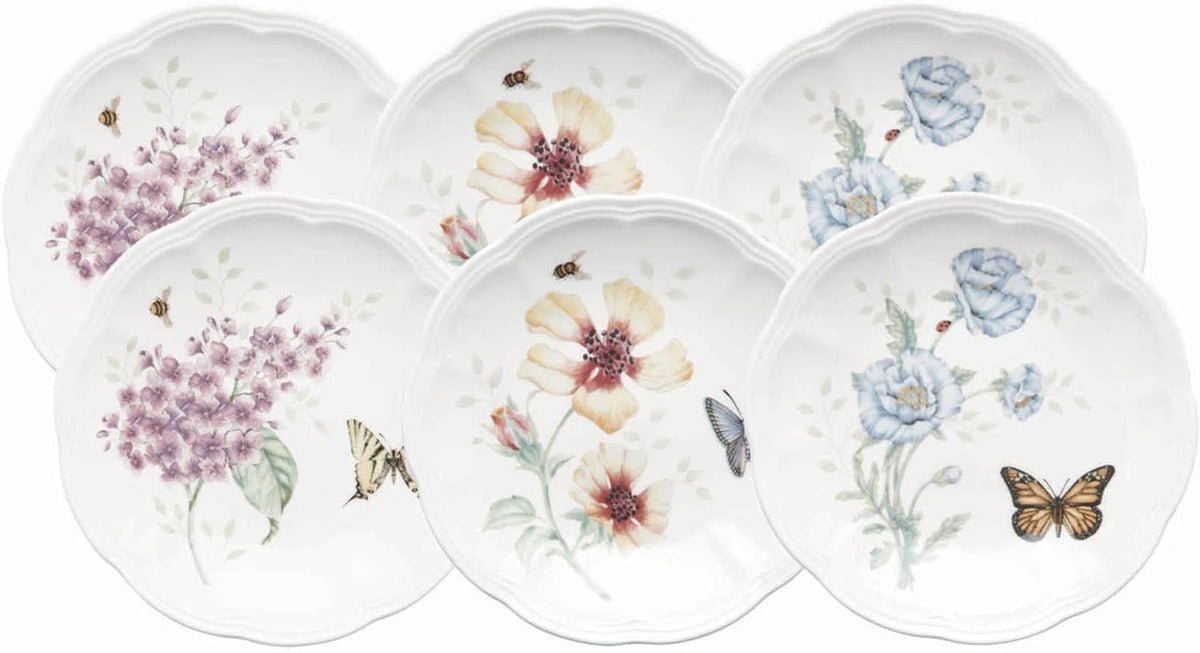 Set of six round tidbit plates with butterfly and floral illustrations on white