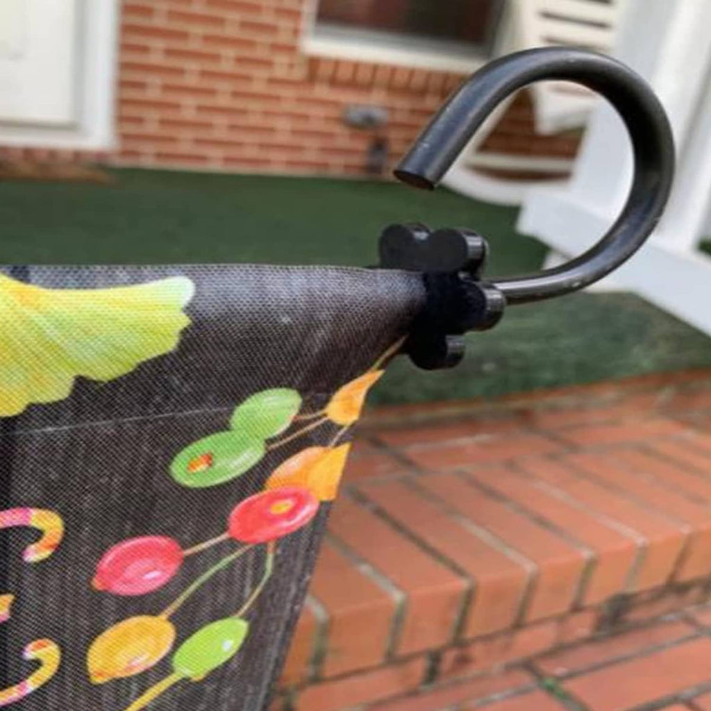 Garden flag fabric mounted on a metal pole, with colorful leaf print