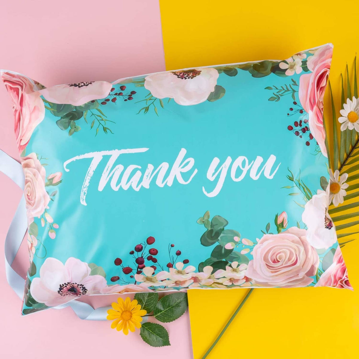 Turquoise floral poly mailer bag featuring 'Thank you' text in white script