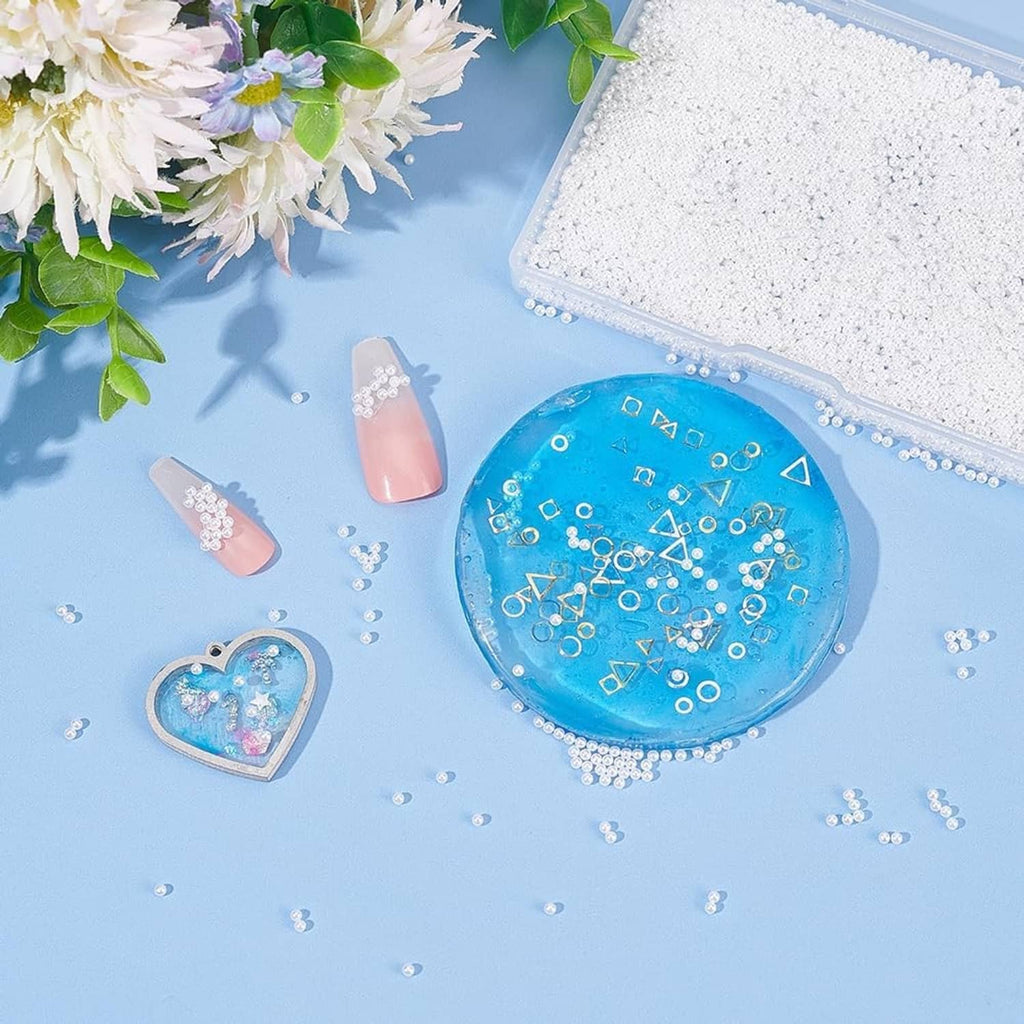 White pearl beads scattered around craft items and small embellishments