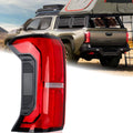 Left rear LED tail light assembly with red lens and clear reflector, black trim housing