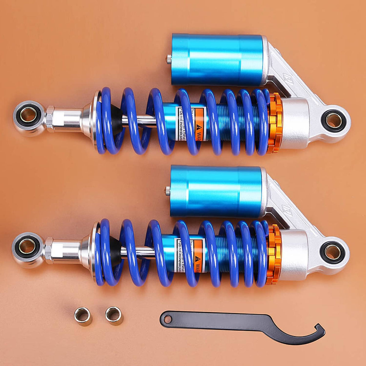 Motorcycle rear air shock absorbers with blue springs, silver cylinders, and included wrench
