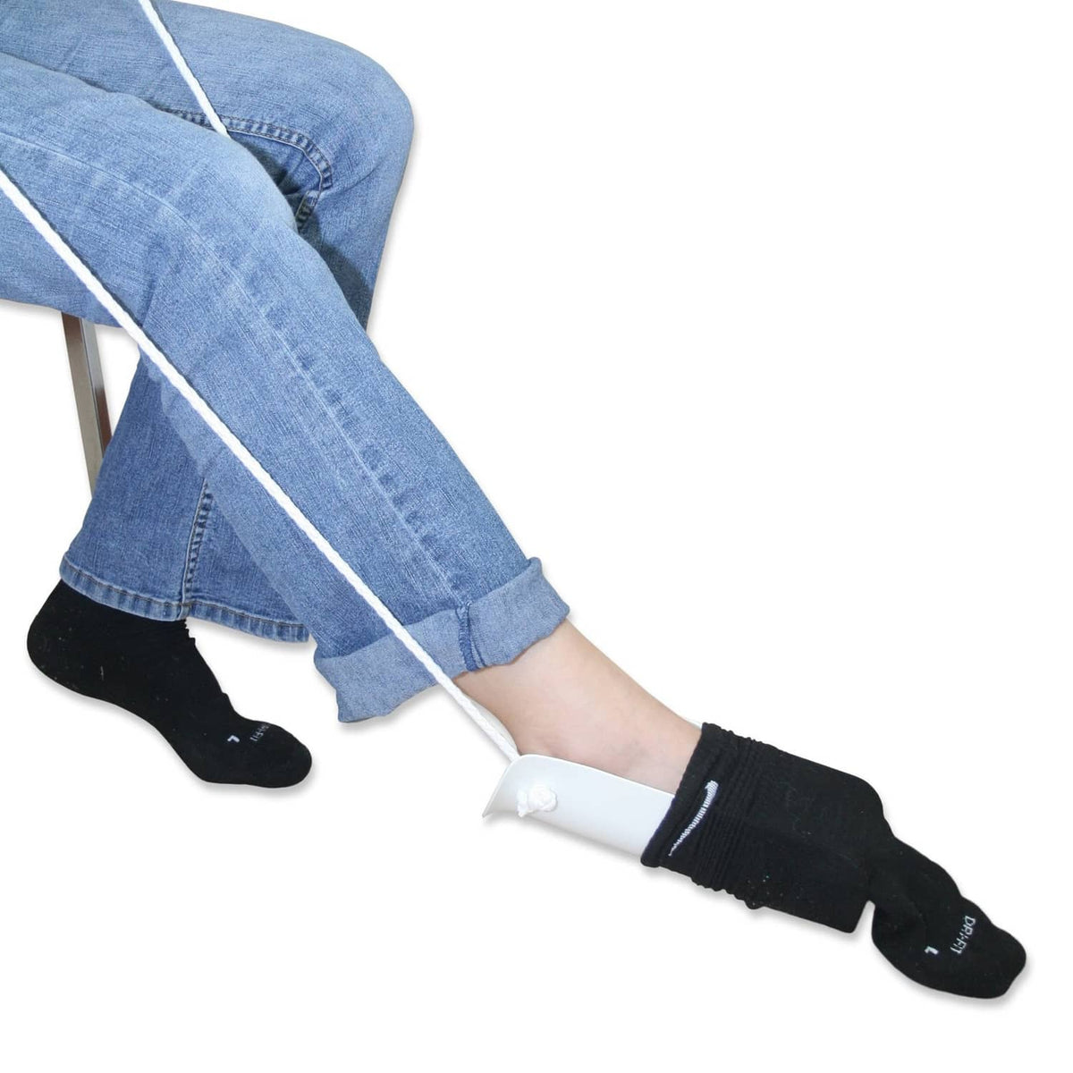 Sock aid tool helping pull on dark socks with white base and black grip