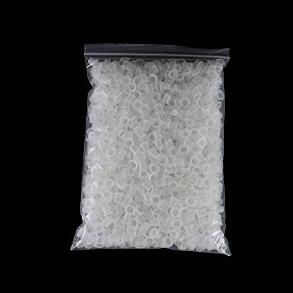 Bag of disposable clear tattoo ink pigment caps, small round cups inside