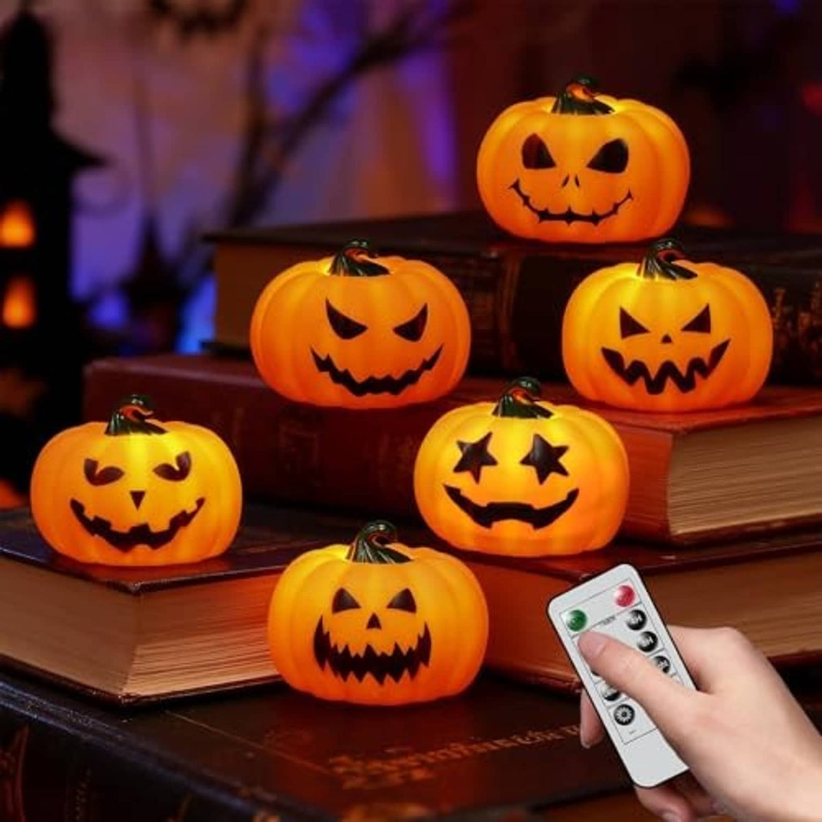 Halloween orange pumpkin tea lights with glowing faces and handheld remote