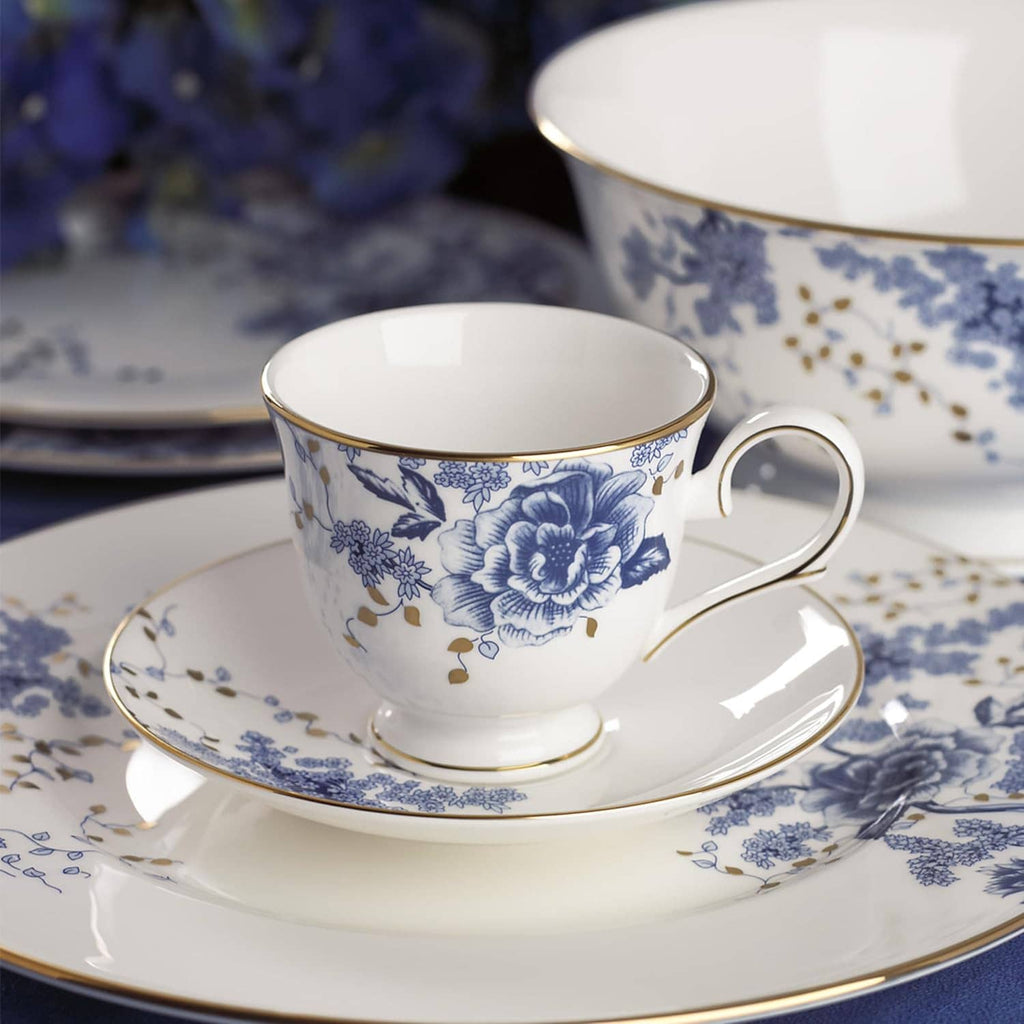 Blue floral porcelain teacup with handle and matching saucer with gold rim
