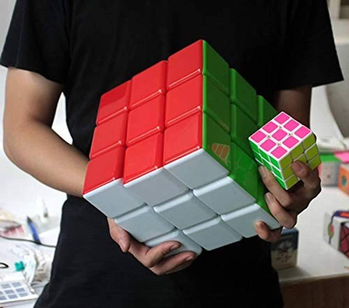 Stickerless 3x3 speed cube with red and green faces and small pink-pattern cube.