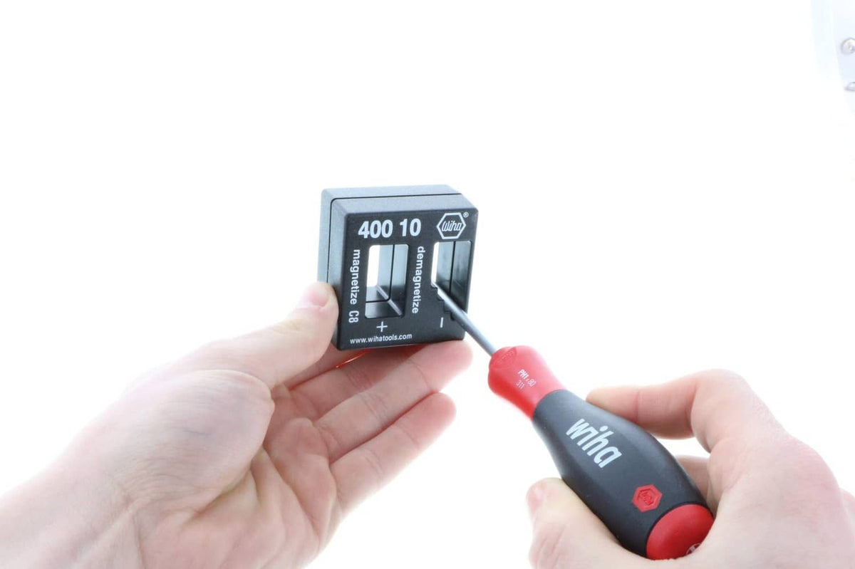 Wiha magnetizer/demagnetizer block held while using a red-and-black handle tool