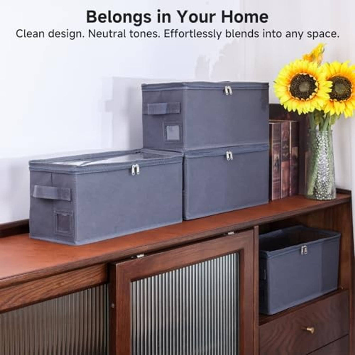 Set of dark gray CD storage cases with lids and front pockets, stacked on a shelf