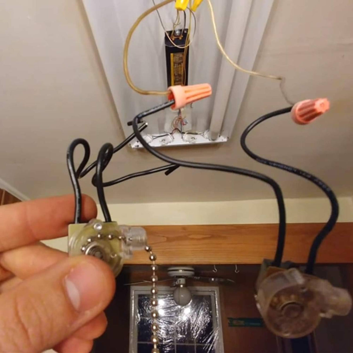 Installed ceiling fan pull chain switch with clear housing and pull chain