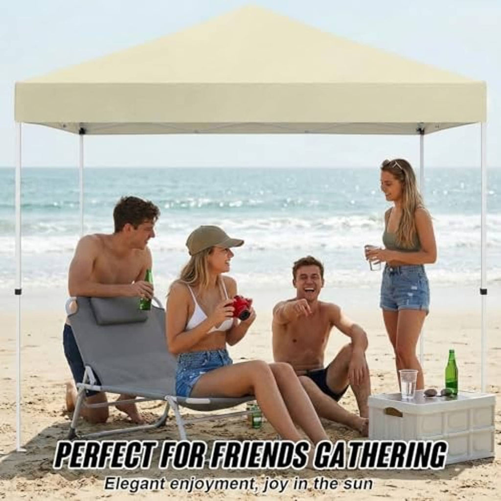 Beige canopy top over beach gathering table with four corner support poles