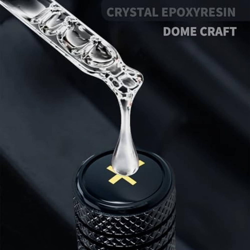 Black metal tire valve stem cap with yellow cross emblem, standalone