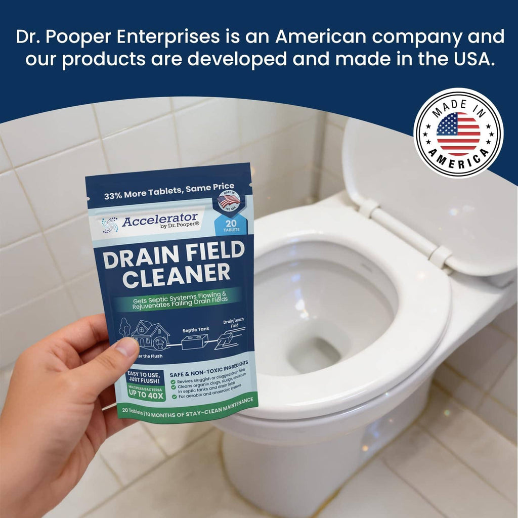 Hand holding Drain Field Cleaner 20-tablet package next to an open toilet bowl