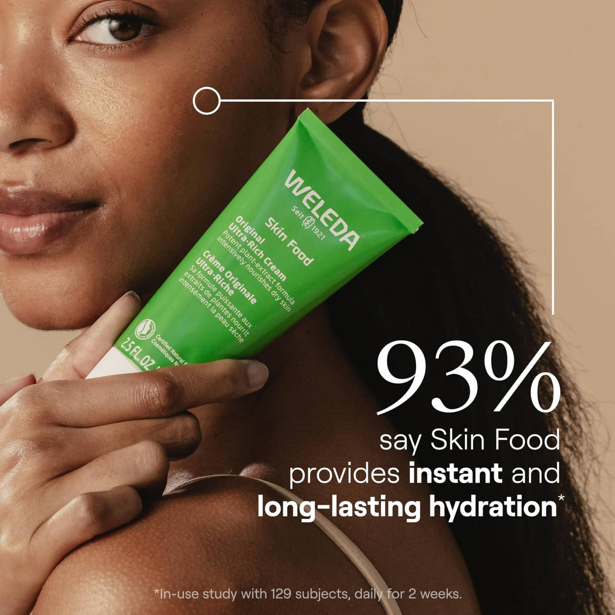 Green skin food body cream tube held near face for hydration