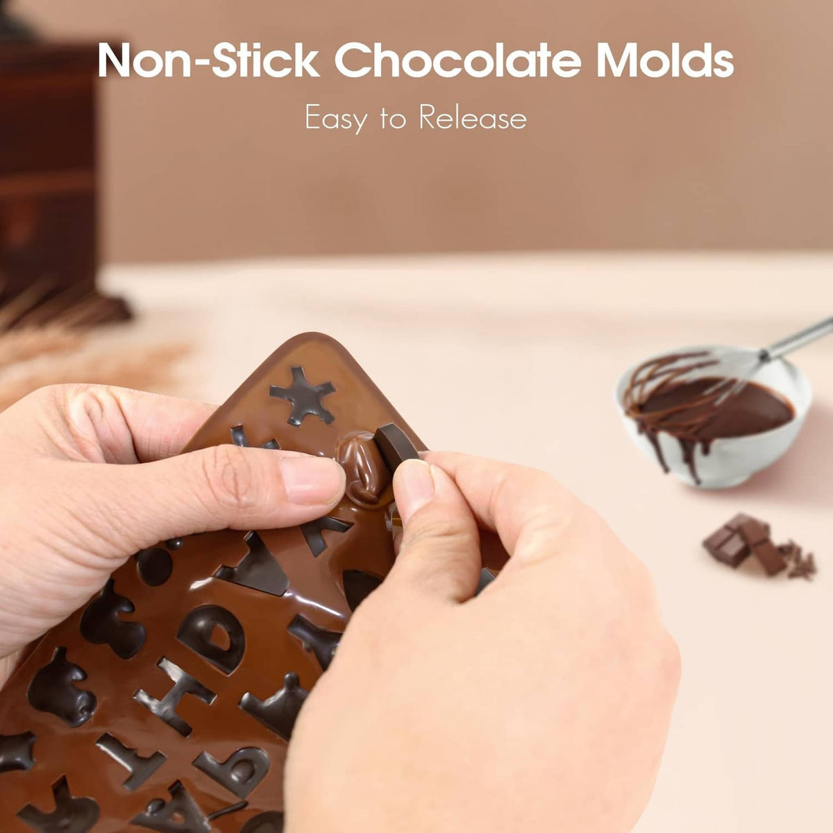Non-stick silicone chocolate letter mold held by hands, showing letter cutouts