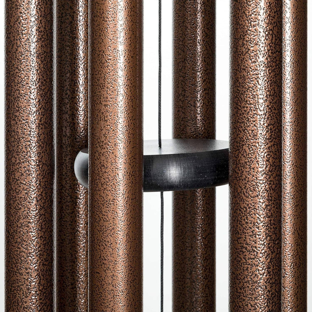 Copper vein wind chime rods around a circular black support plate