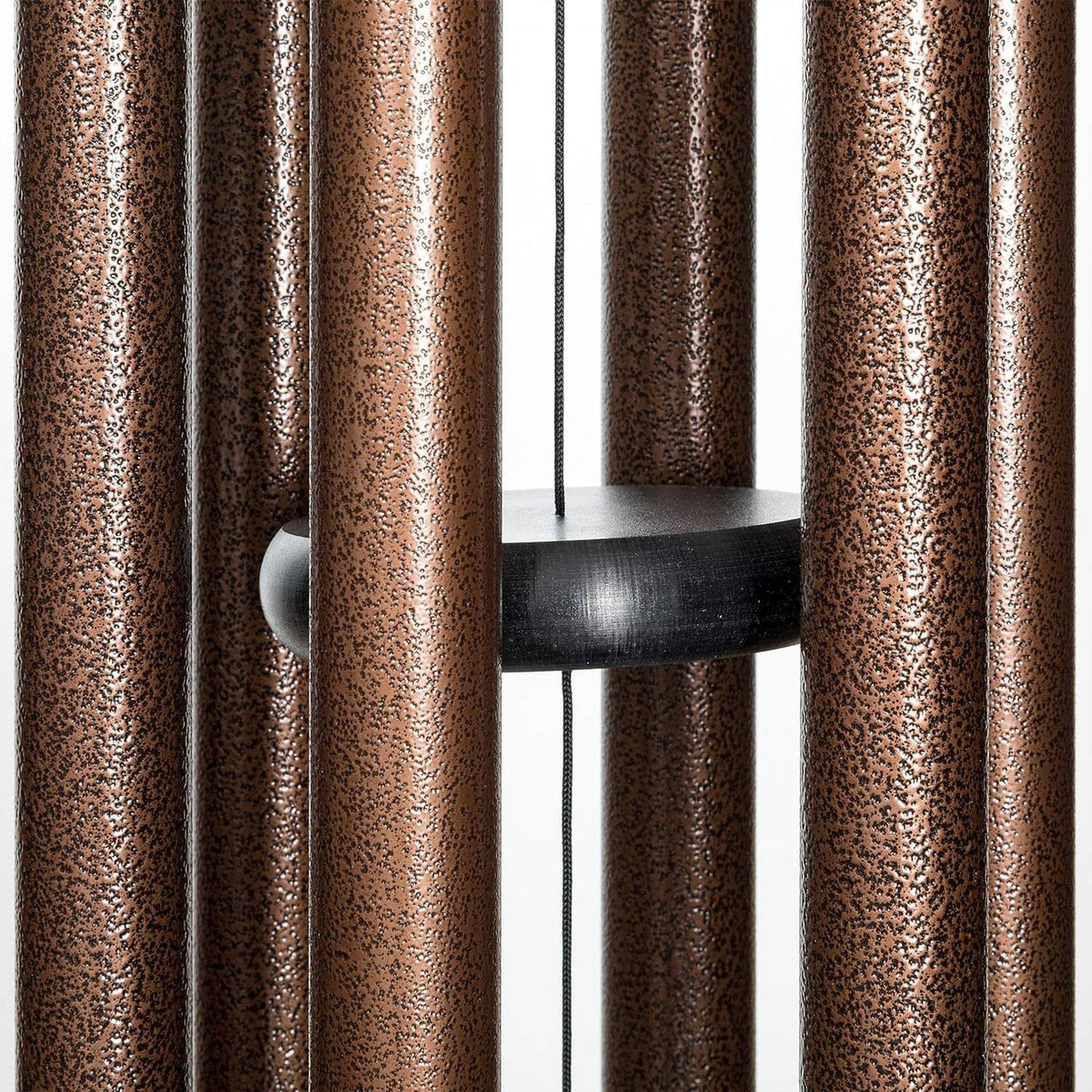 Copper vein wind chime rods around a circular black support plate