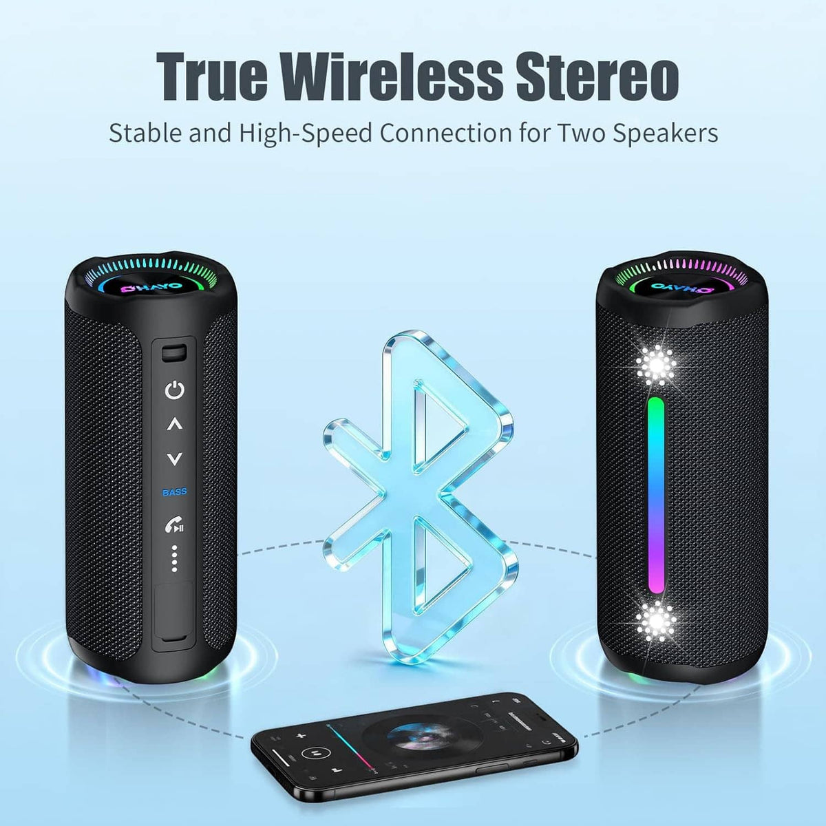 Pair of black cylindrical wireless Bluetooth speakers with RGB LED accents and phone nearby