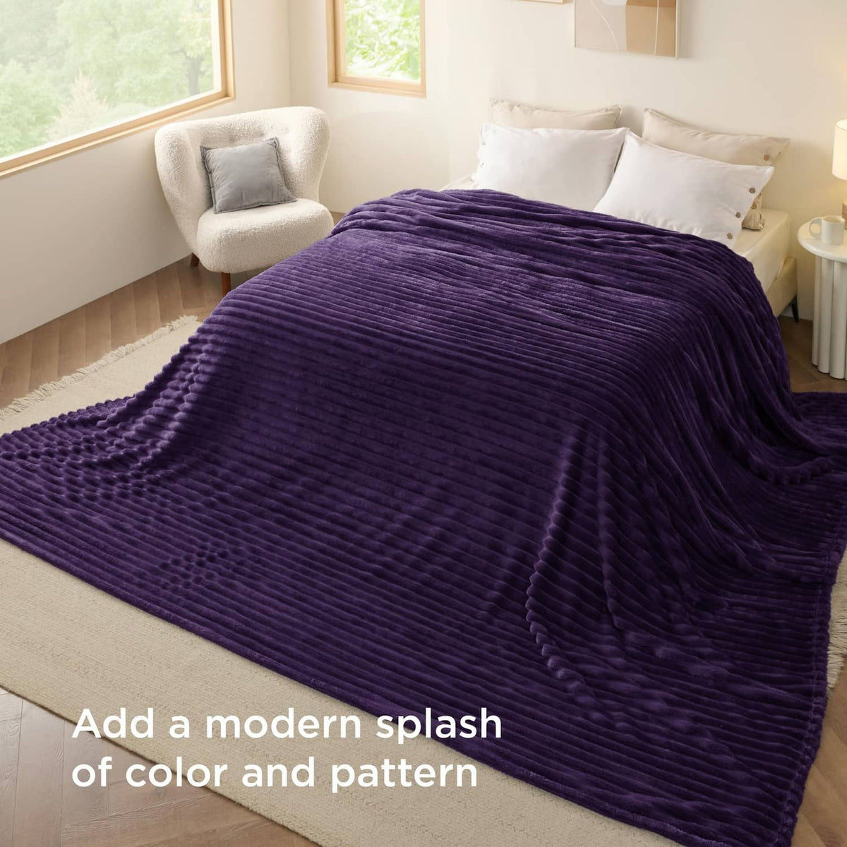 Purple fleece blanket draped on a bed with textured stripe ridges
