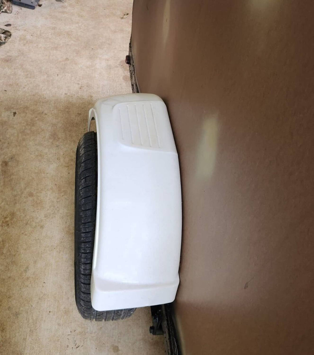 White plastic fender covering a 13-inch wheel on a single-axle trailer