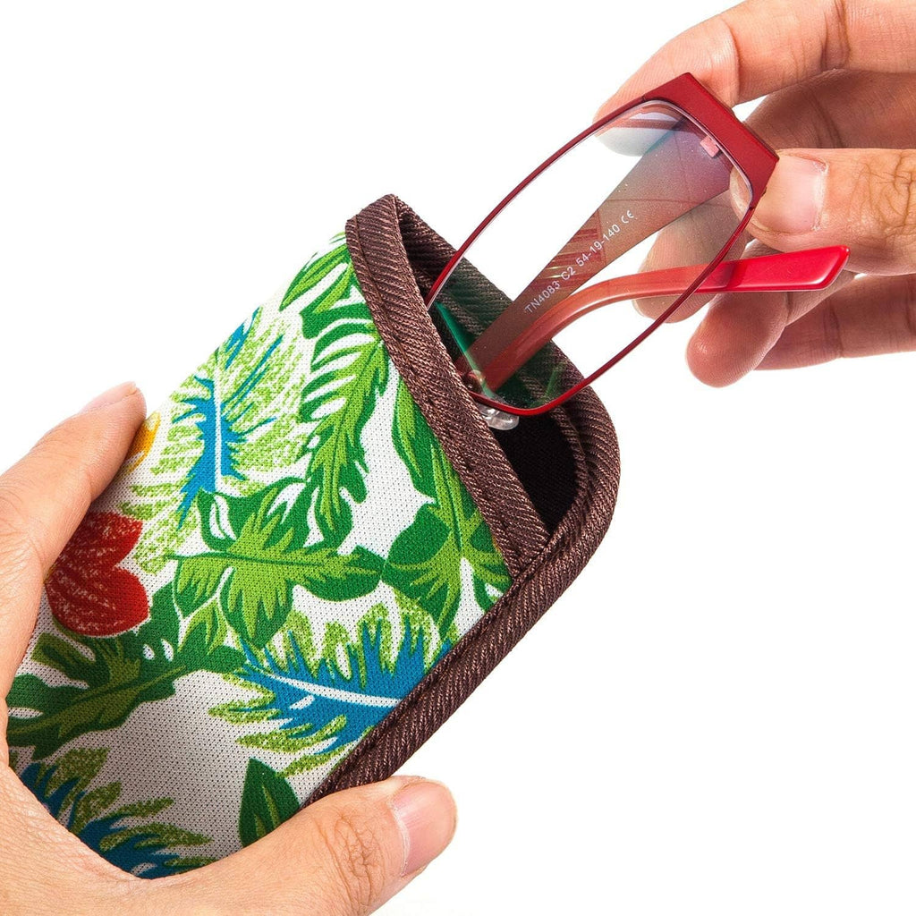 Tropical leaf eyeglasses pouch with brown trim; hand holding the slim padded sleeve