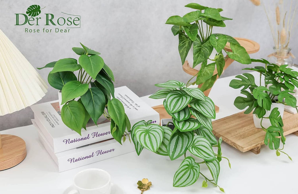 Leafy artificial plants with broad and striped green leaves in white square pots