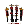 Coilover lowering suspension kit with four shock struts, red springs, black bodies, gold mounts.