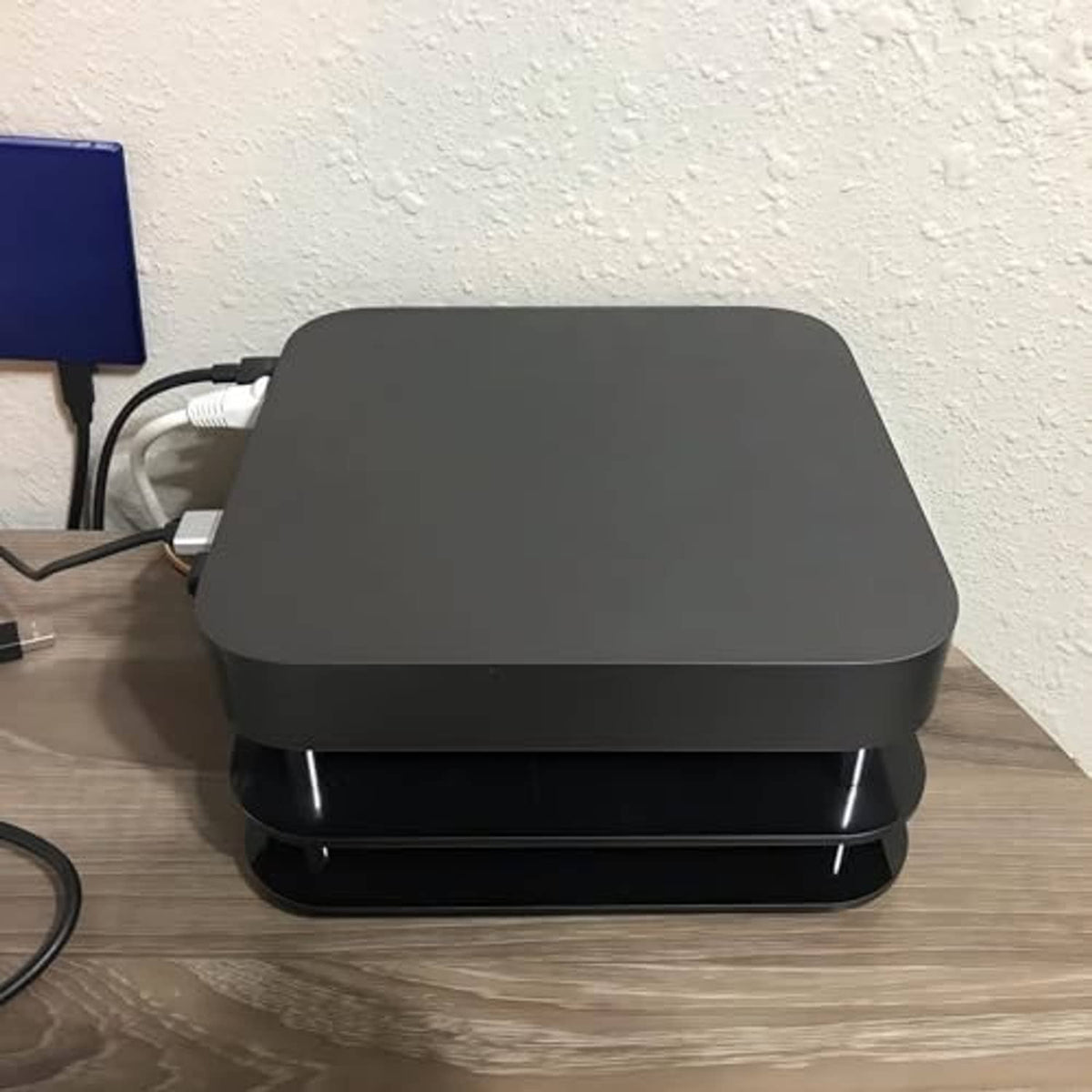 Compact Mac mini radiator cooling fan on a desk, black top and base with fan grill