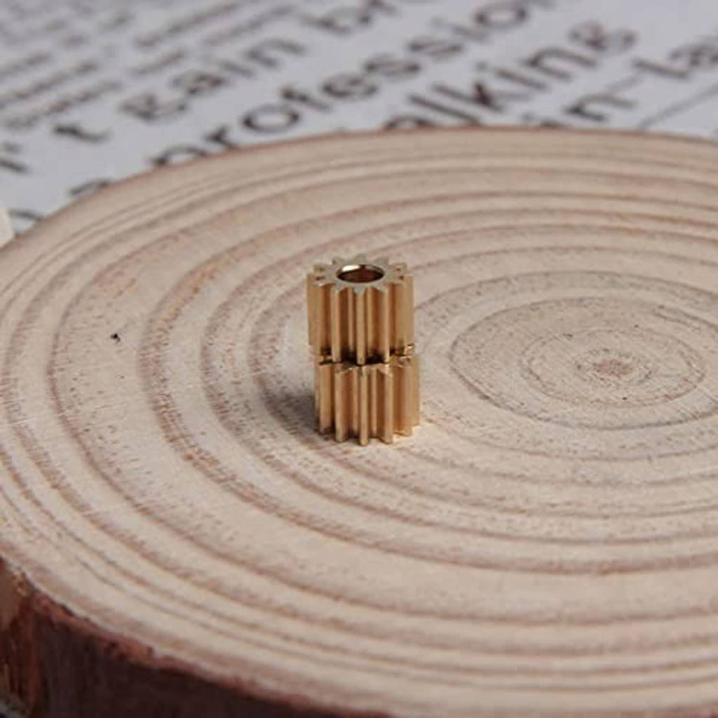 Copper 12-tooth spur gear with 3 mm bore, front view on a wooden slice